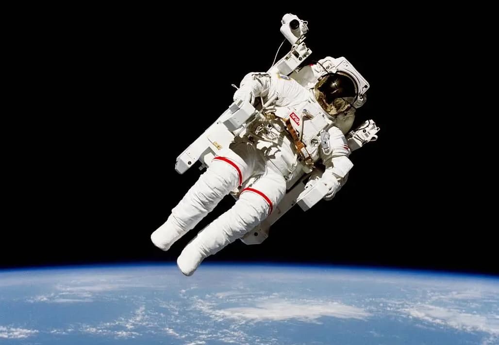Suspended above Earth, an astronaut floats: self-contained, weightless, still tethered by belief in the system guiding them from afar. Quietly held in place by trust and coordination. Image Credit: Nasa.